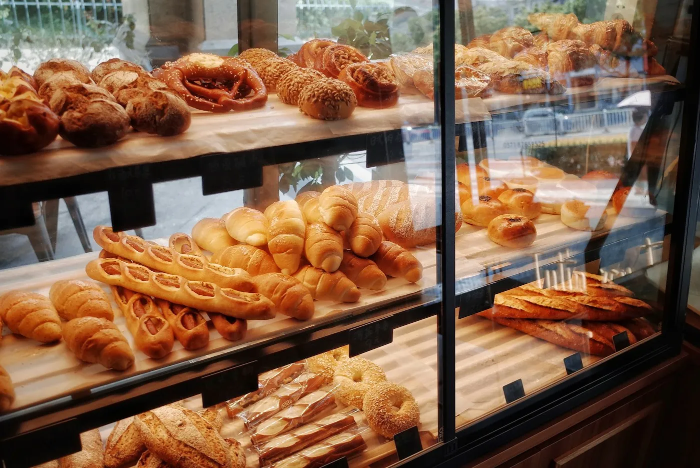 Shelves of fresh bread, rolls and baguettes on display